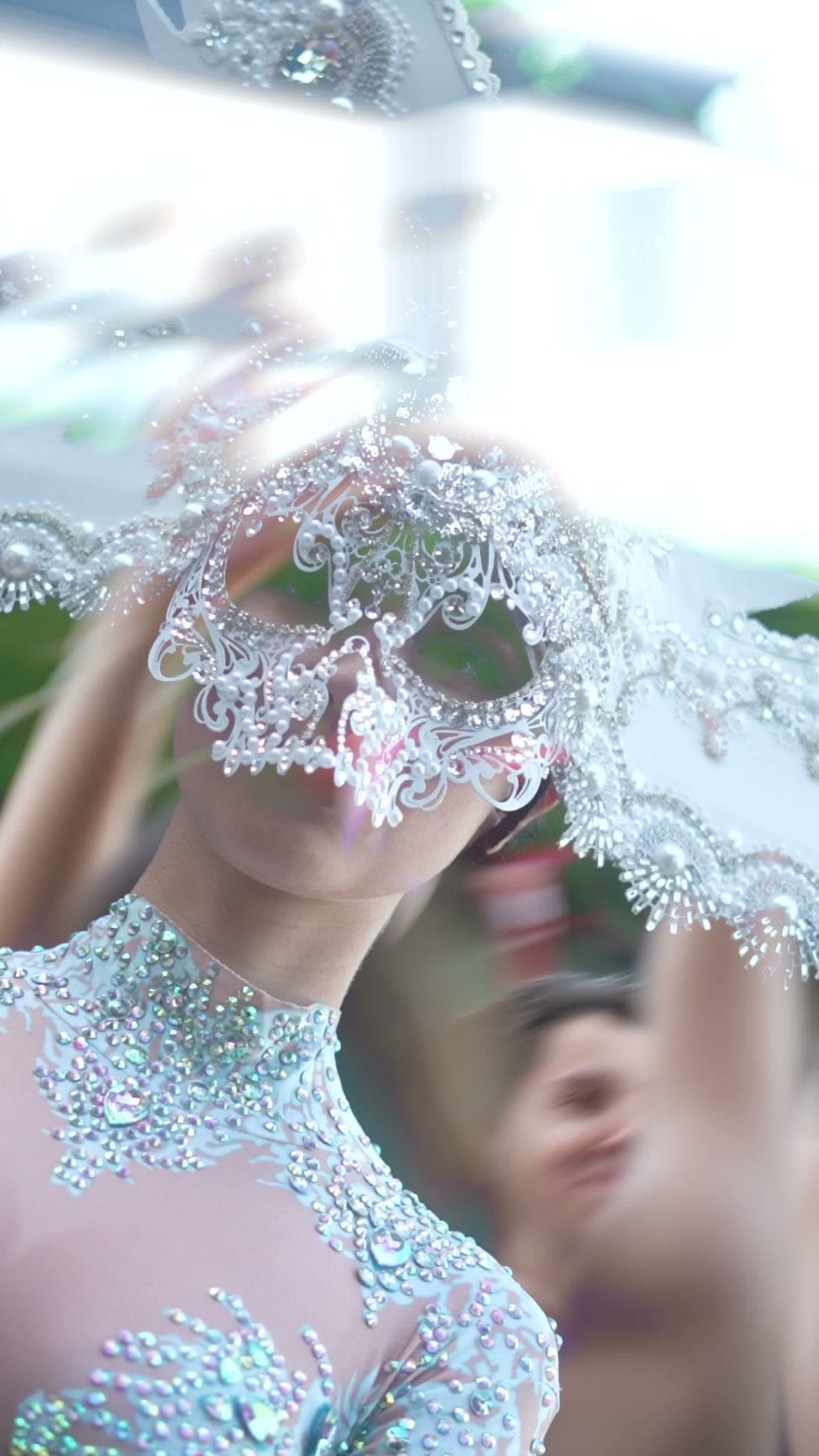 Close-up of a performer in a jewelled masquerade mask